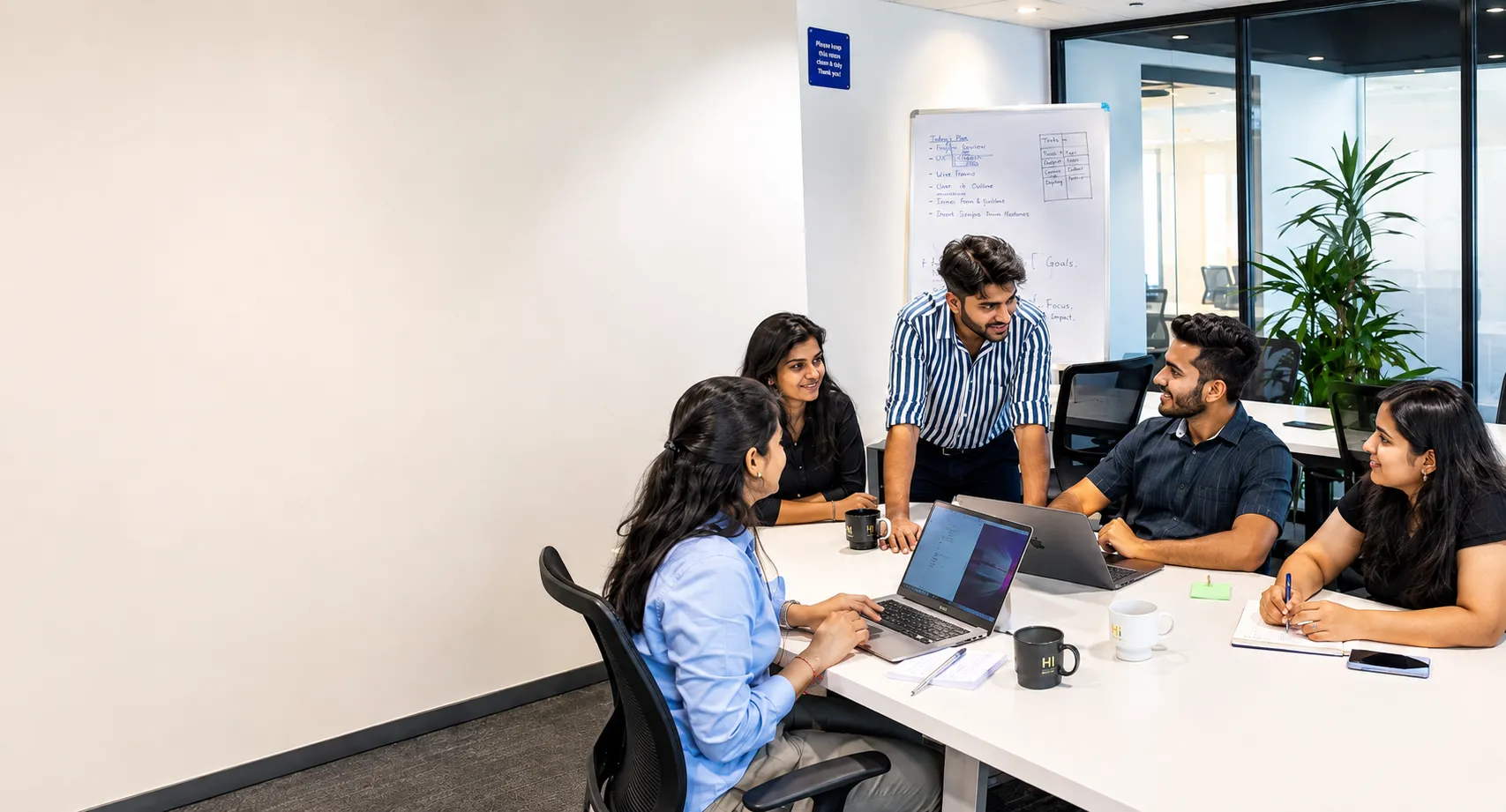 People discussing website strategy together around a laptop
